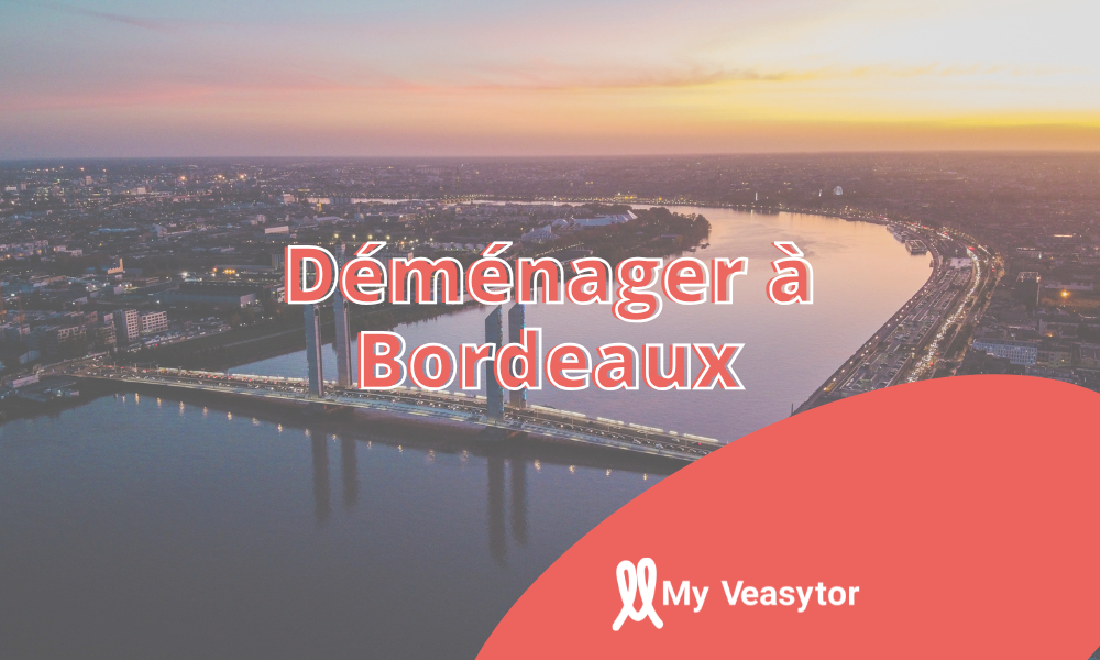 Vue aérienne de Bordeaux au coucher du soleil avec le pont levant Jacques Chaban-Delmas et la Garonne.